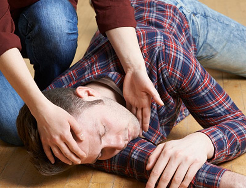 A man being put into the recovery position