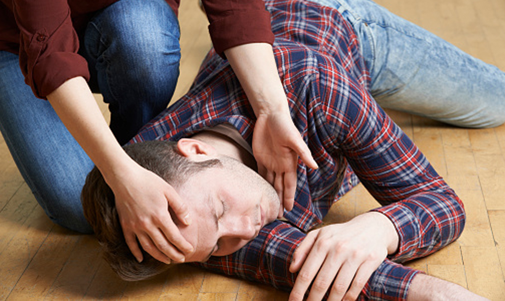 A man being put into the recovery position