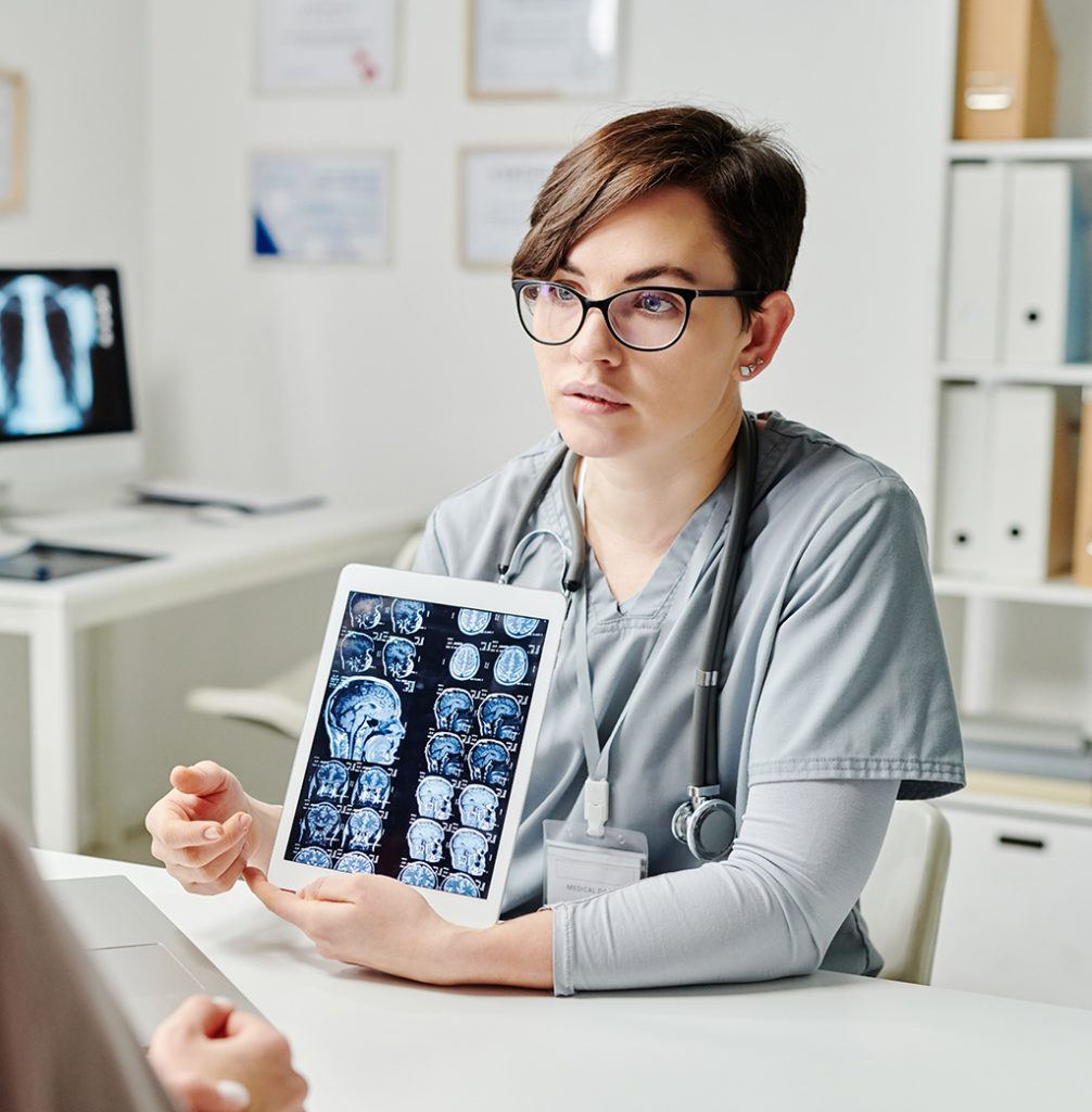 A radiologist showing a brain scan to their patient