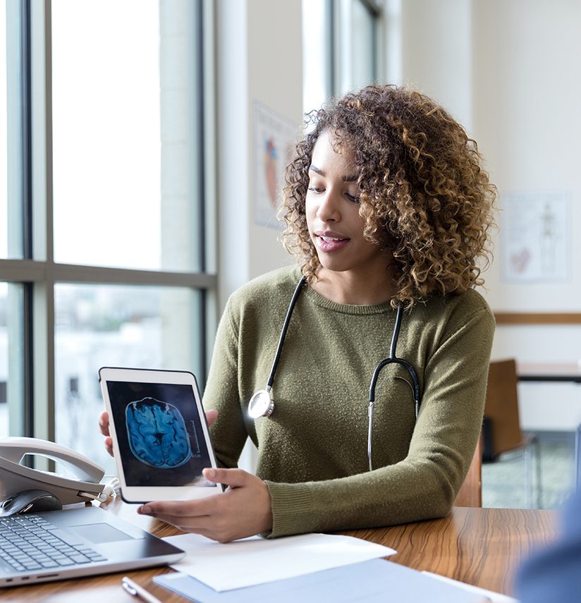 A neurologist discusses MRI scan with patient