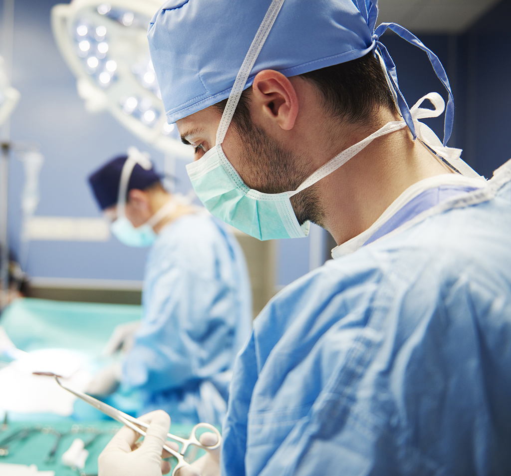 Doctor in surgery about to install a vagus nerve stimulation (VNS) device