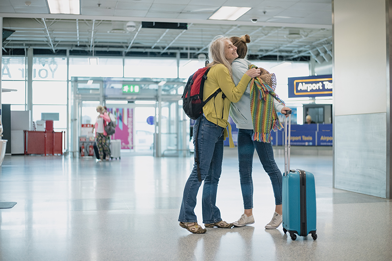 A mother greeting her daughter travelling abroad with epilepsy at an airport