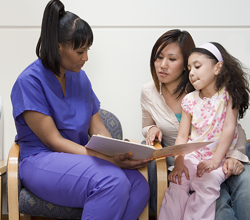 Nurse talking to mother and daughter