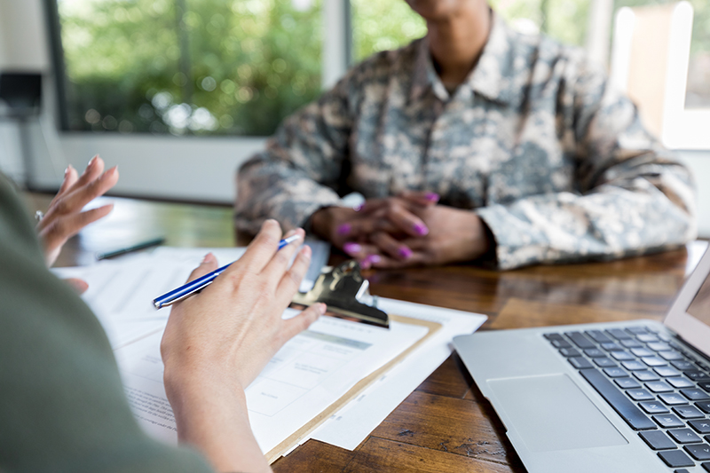 Female financial advisor talks with veteran