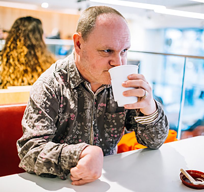 Adult with a learning disability and epilepsy sitting in a restaurant.