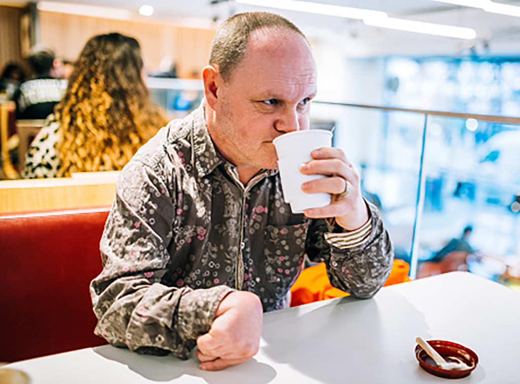 Adult with a learning disability and epilepsy sitting in a restaurant.