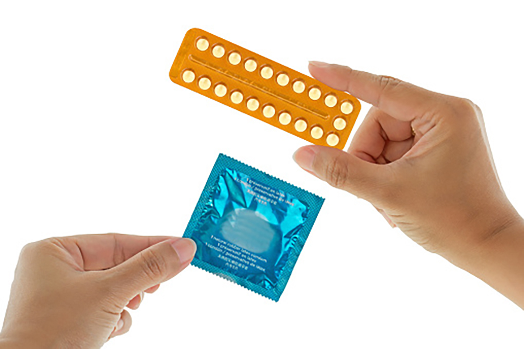 A Packet of contraception pills and a blue packaged condom