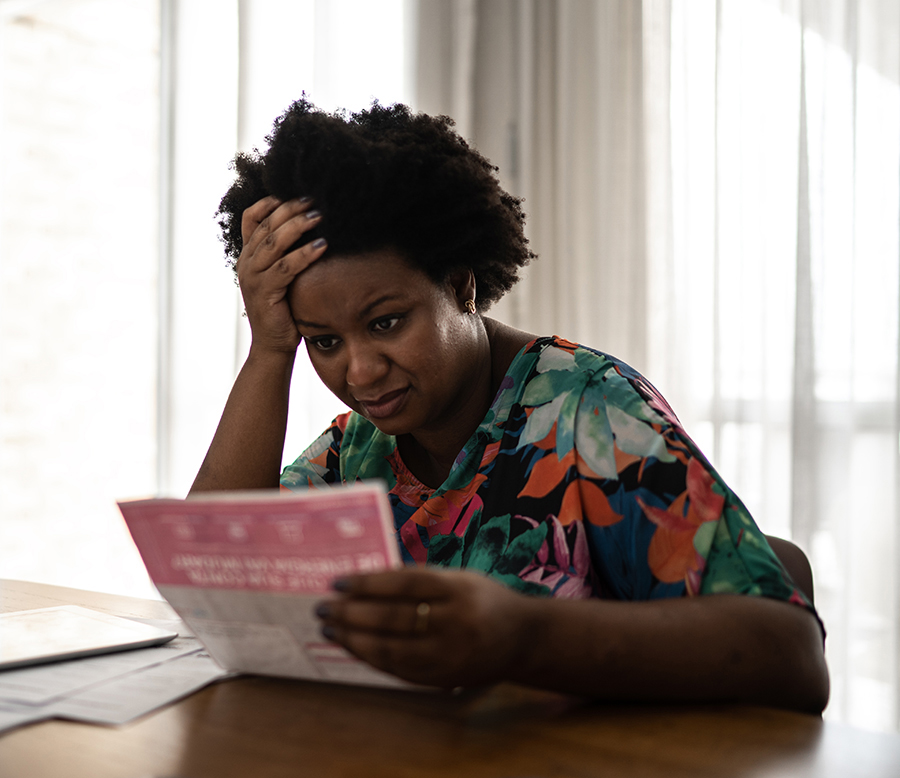 Worried woman looking for financial bills at home