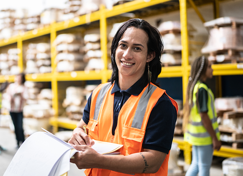 A warehouse employee taking inventory in a factory