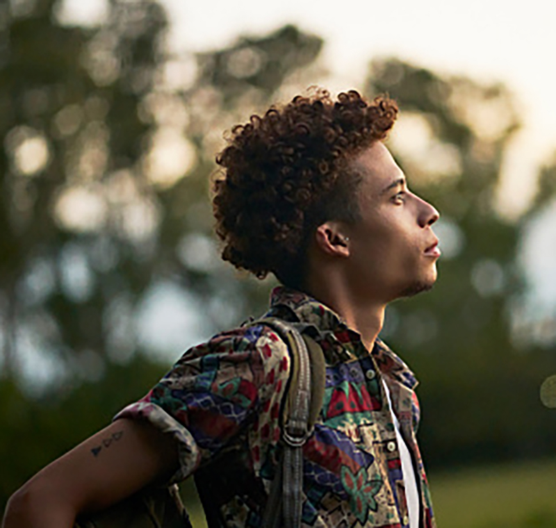 A young man staring hopefully into the distance