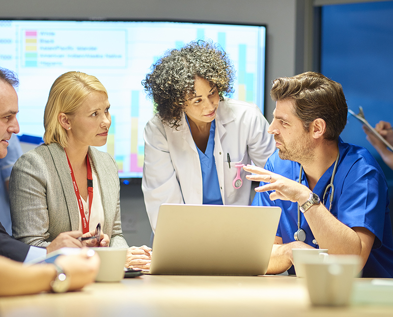 A group of business people meeting around a conference table