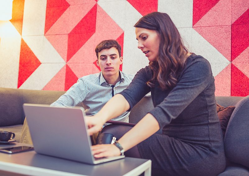 Two people looking at a laptop