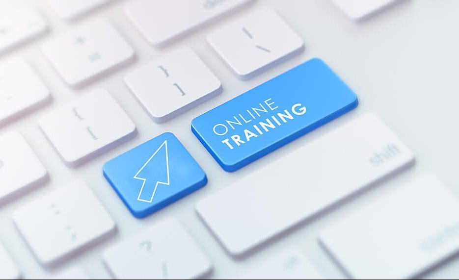 A keyboard with a key depicting a computer mouse icon and a key with text saying online training A keyboard with a key depicting a computer mouse icon and a key with text saying online training