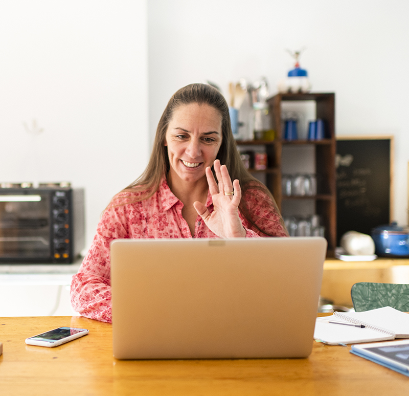 Woman greeting colleagues on video conference Woman greeting colleagues on video conference