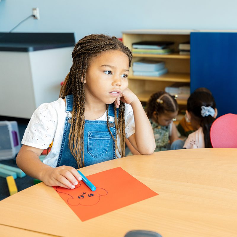 Young girl stops colouring due to having an absence seizure