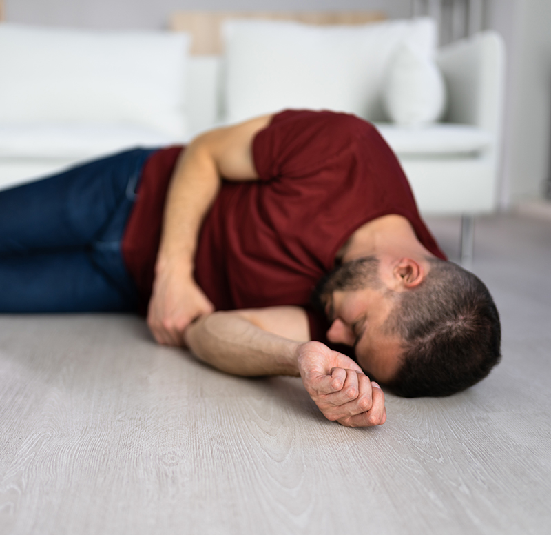 Unconscious Young Man Lying On Floor