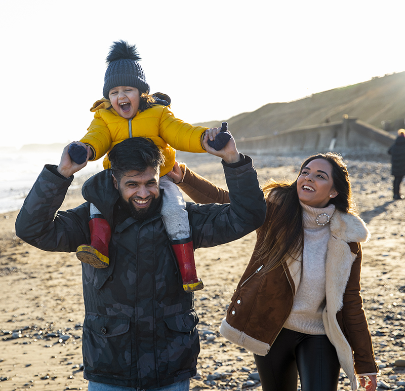 A family walking along a beach