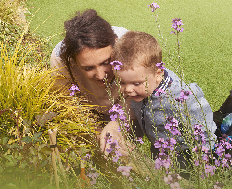 Toddler and mother playing in a garden