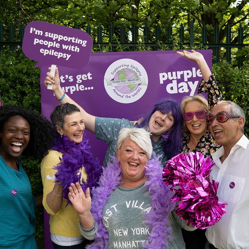 A group of people celebrating purple day