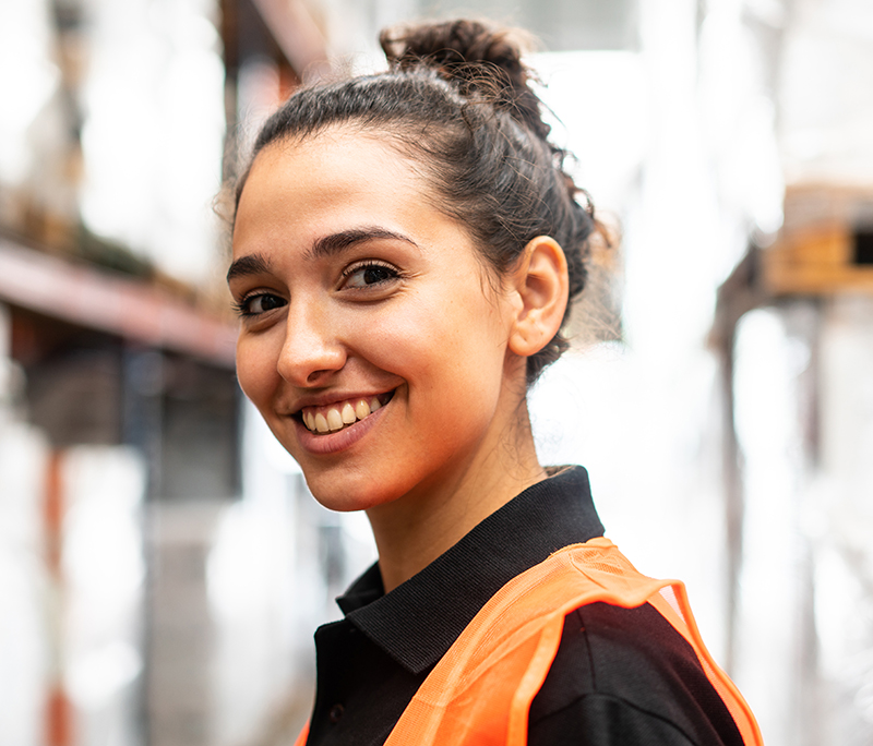 Close-up of a happy woman working in warehouse