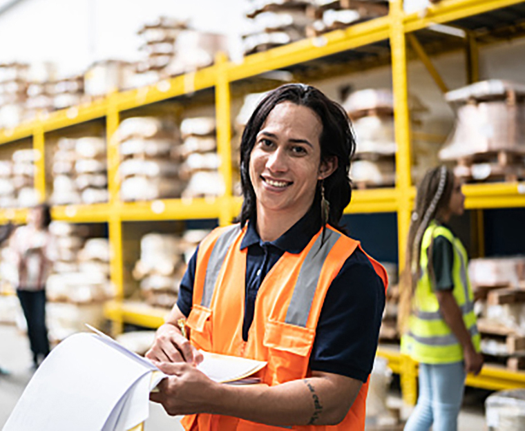 A warehouse employee taking inventory in a factory