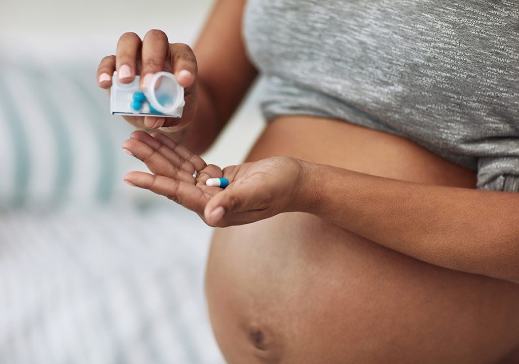 pregnant woman taking medicine