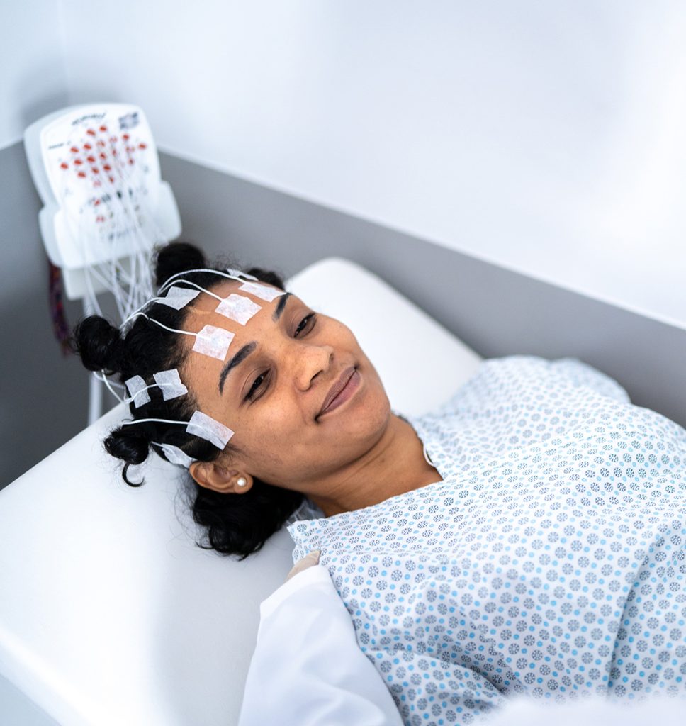 Female patient about to take an EEG (electroencephalogram)