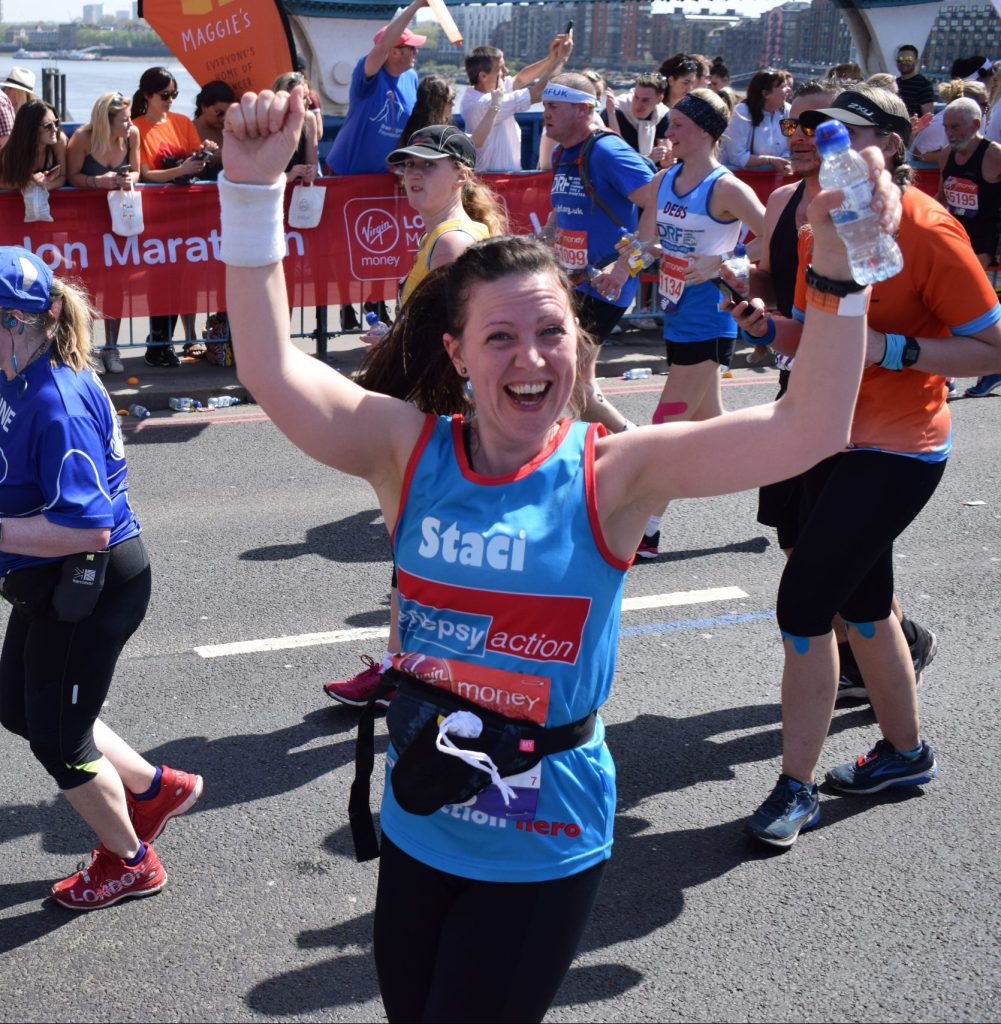 Smiling woman running in Cardiff half marathon