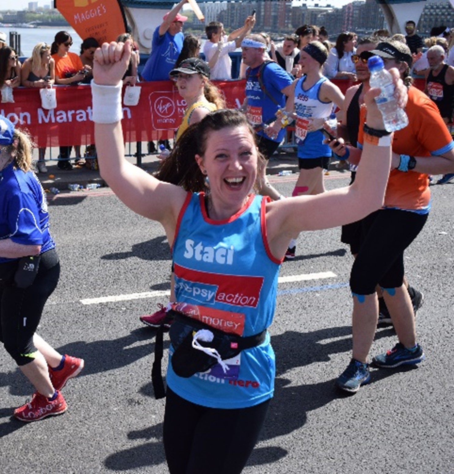 Smiling woman running in Cardiff half marathon