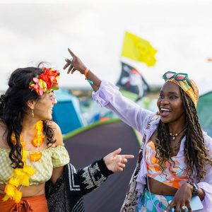 Two women chat at a music festival