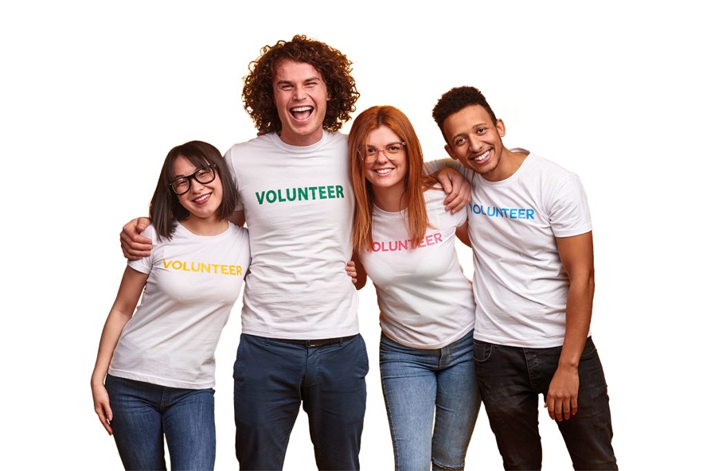 A group of four young volunteers smiling