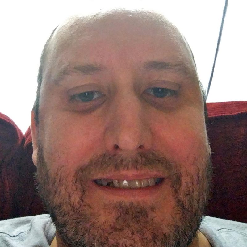 Photo of EA befriender Chris, smiling. Photo of EA befriender Chris, smiling.