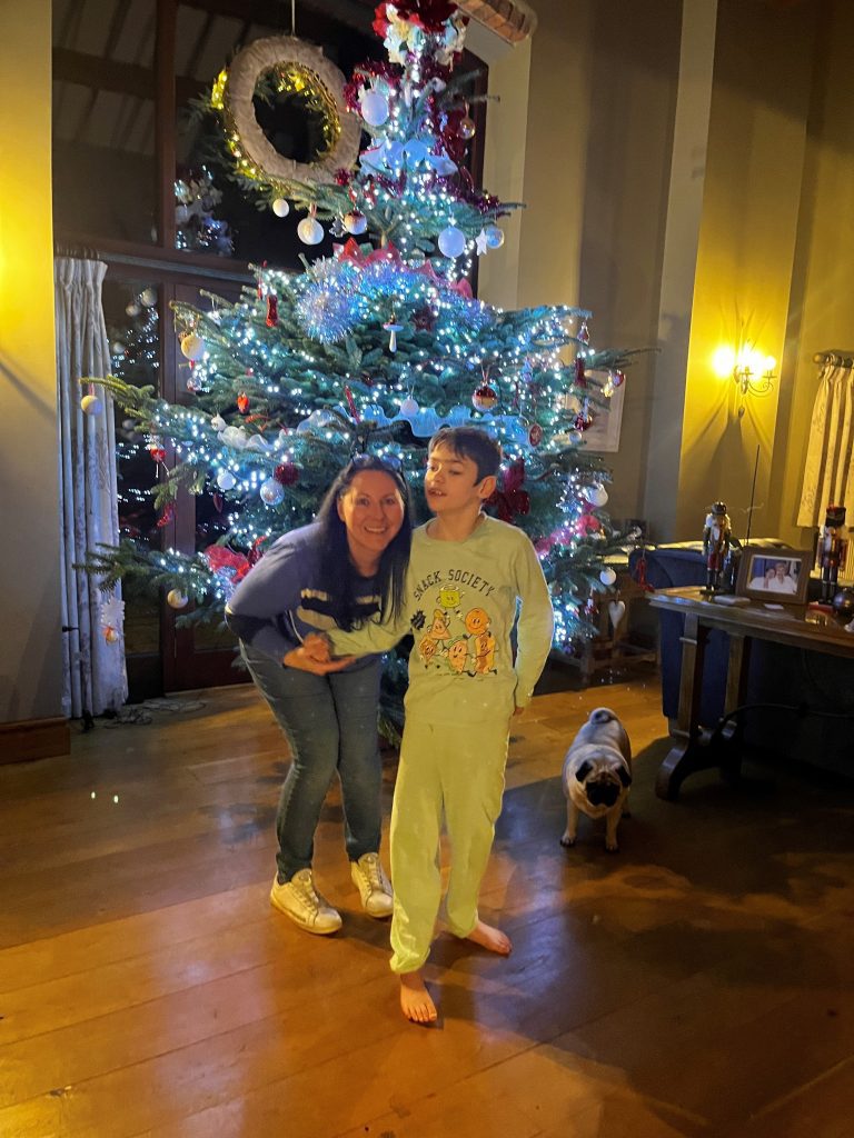 Joanne and Ben standing next to a festive looking tree.