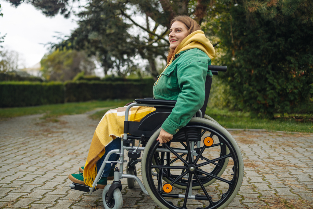 A woman outdoors in a wheelchair