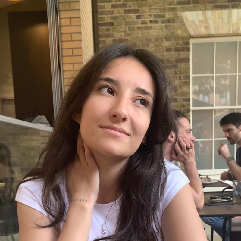 Image of Leti, a young woman with long brown hair and a white top