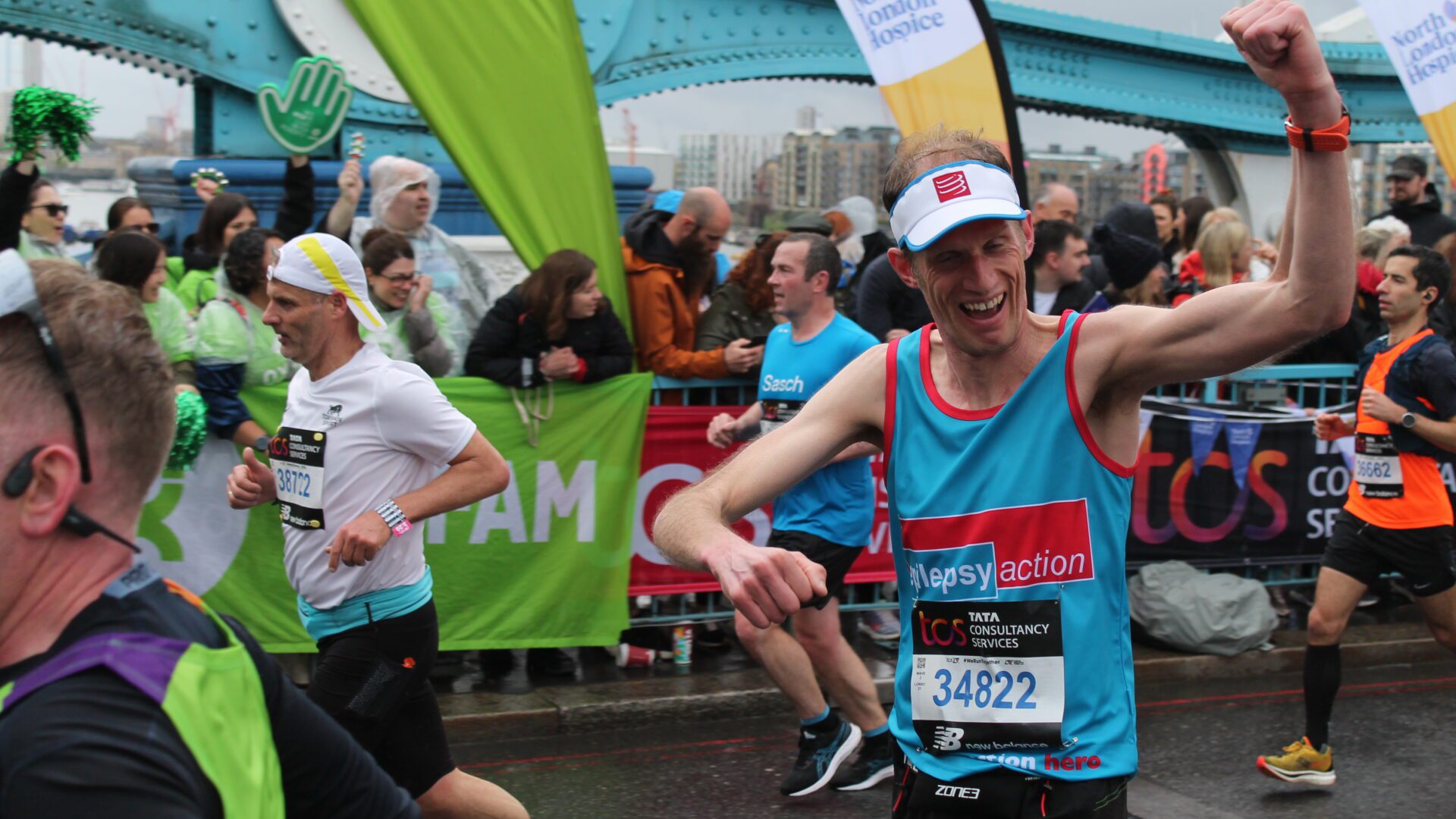 London Marathon 2023 - Epilepsy Action runner passing through cheering point.