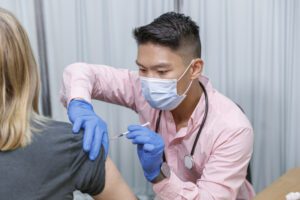 nurse giving a COVID vaccine