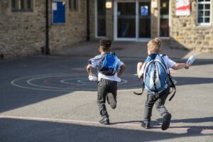 Children running into school
