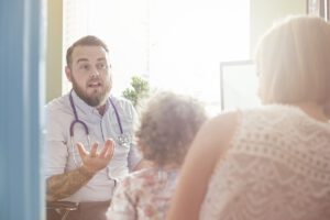 Doctor advising a mum and a child