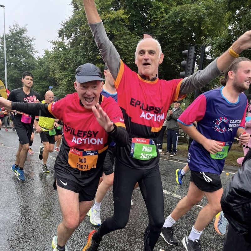 People running cheerfully wearing Epilepsy Action shirts