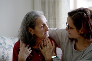 Woman carer hugging her mother