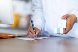 Medical specialist writing a prescription