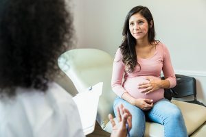 Pregnant woman talking to doctor