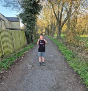 Nyle in an epilepsy action t-shirt on a path during his 20-mile run