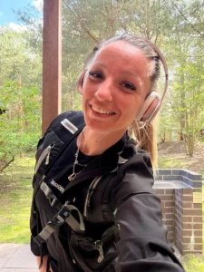 Daisy with headphones and a running vest