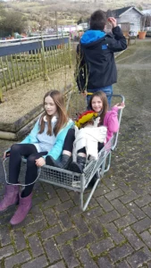 Ruby's family know what it's like when a car passenger has a seizure. Ruby in a trolley with her sister