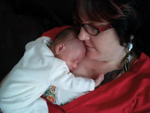 National epilepsy week missing memories campaign: amy-jane with newborn baby joe sleeping on her chest
