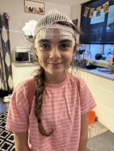 Alana, daughter of May Star Award winner Katherine, with brain scan equipment on her head
