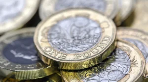 A close up of pound coins in a pile illustrating Timms review interim report on PIP