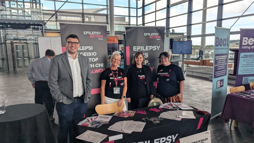 Four people stood at an Epilepsy Action stand at the Senedd. L-R: Chris Pate Epilepsy Action volunteer, Jan Paterson, Epilepsy Action Wales manager, Helen Ross, consulting for Epilepsy Action and Becci Smart, Epilepsy Action volunteer.